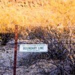Simple sign reading “boundary line” against a clean background