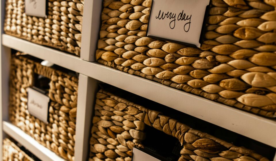 Close-up of neatly organized baskets with labels, showing a simple home organization system that reduces clutter and overwhelm.