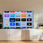 Flat screen television sitting on a white cabinet in a living room