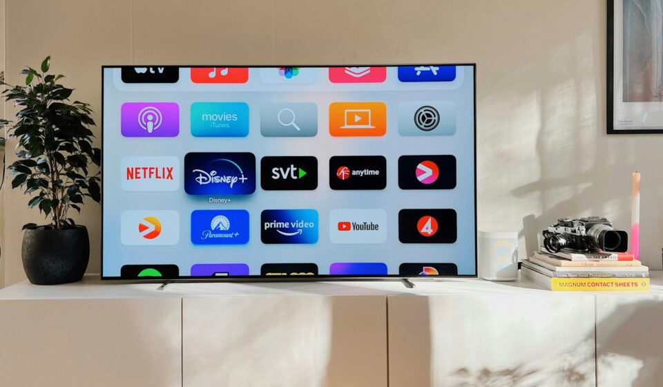 Flat screen television sitting on a white cabinet in a living room