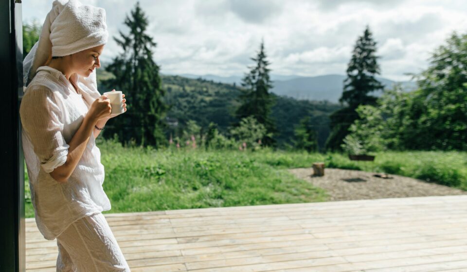 Woman enjoying a quiet morning moment with a cup of coffee in soft natural light