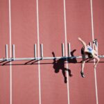 Female athlete running alone on a track during training