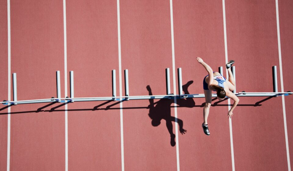 Female athlete running alone on a track during training