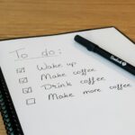 Notepad with a handwritten list and a pen on a desk