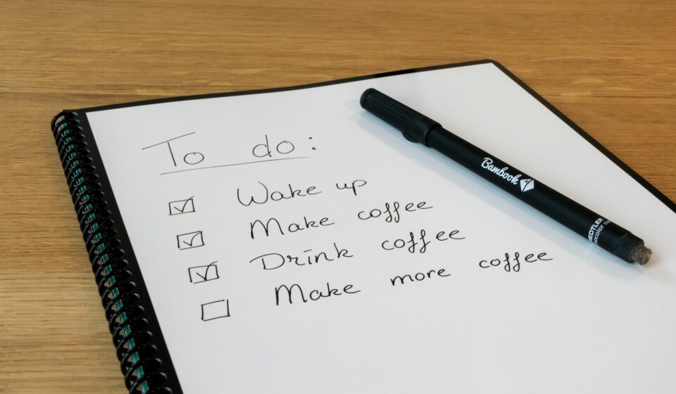 Notepad with a handwritten list and a pen on a desk