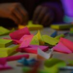 Surface covered with many colorful sticky notes representing multiple tasks and competing thoughts