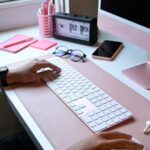 Person working at a clean desk with a computer in a calm, organized workspace