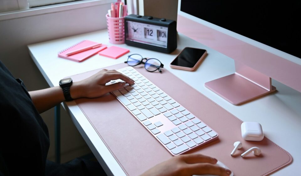 Person working at a clean desk with a computer in a calm, organized workspace