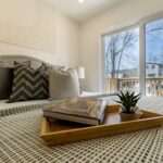 Cozy bed with a tray holding books in a calm and comfortable bedroom